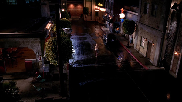 Buffy walks alone through a street.