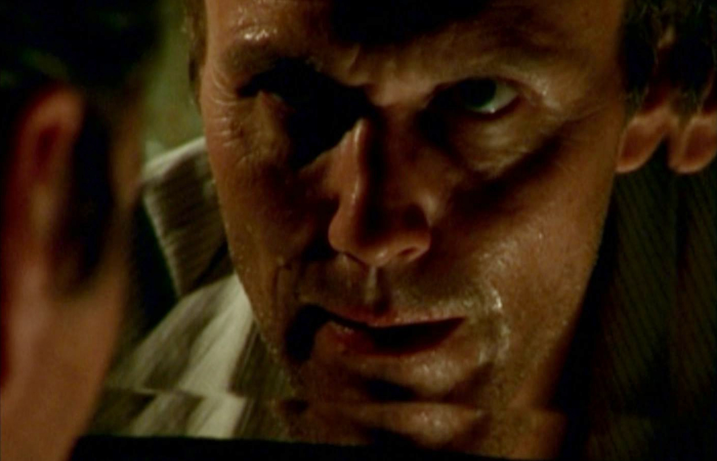 Giles looks at himself in a mirror