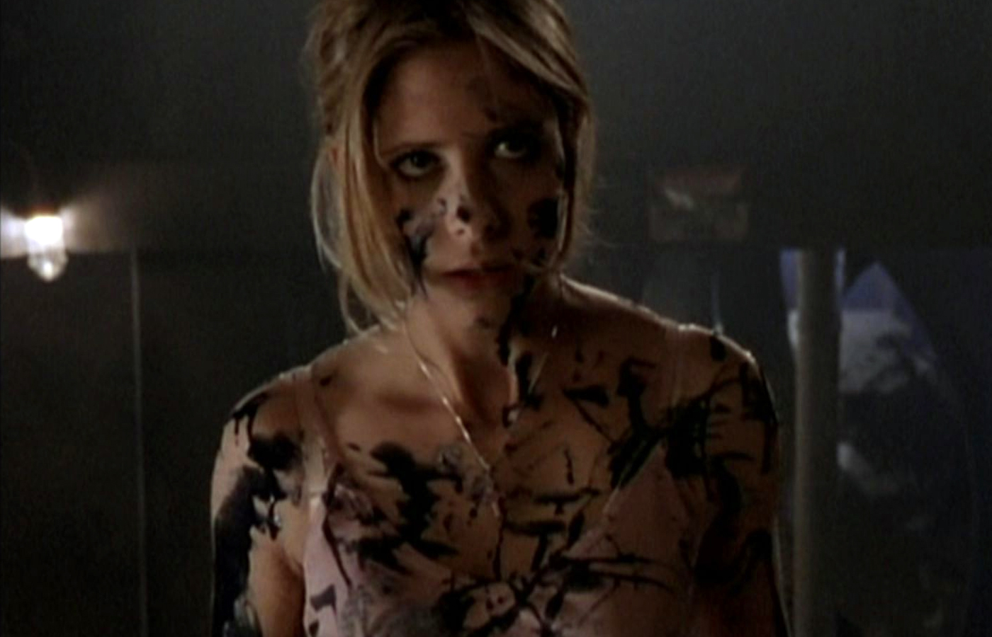 Buffy stares, covered in black demon blood.