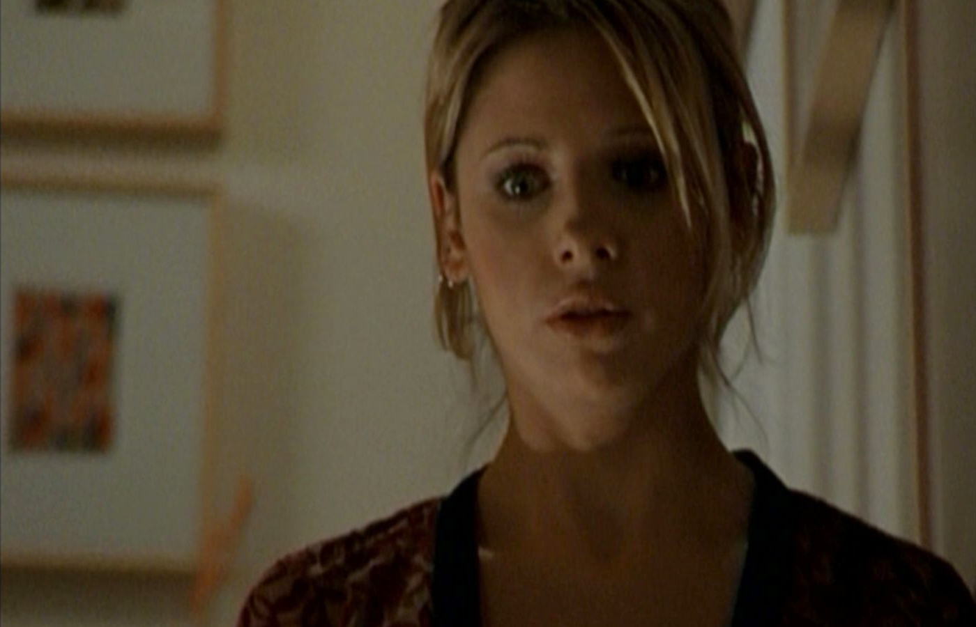 Buffy looks at Ted's dead body from the top of the stairs.