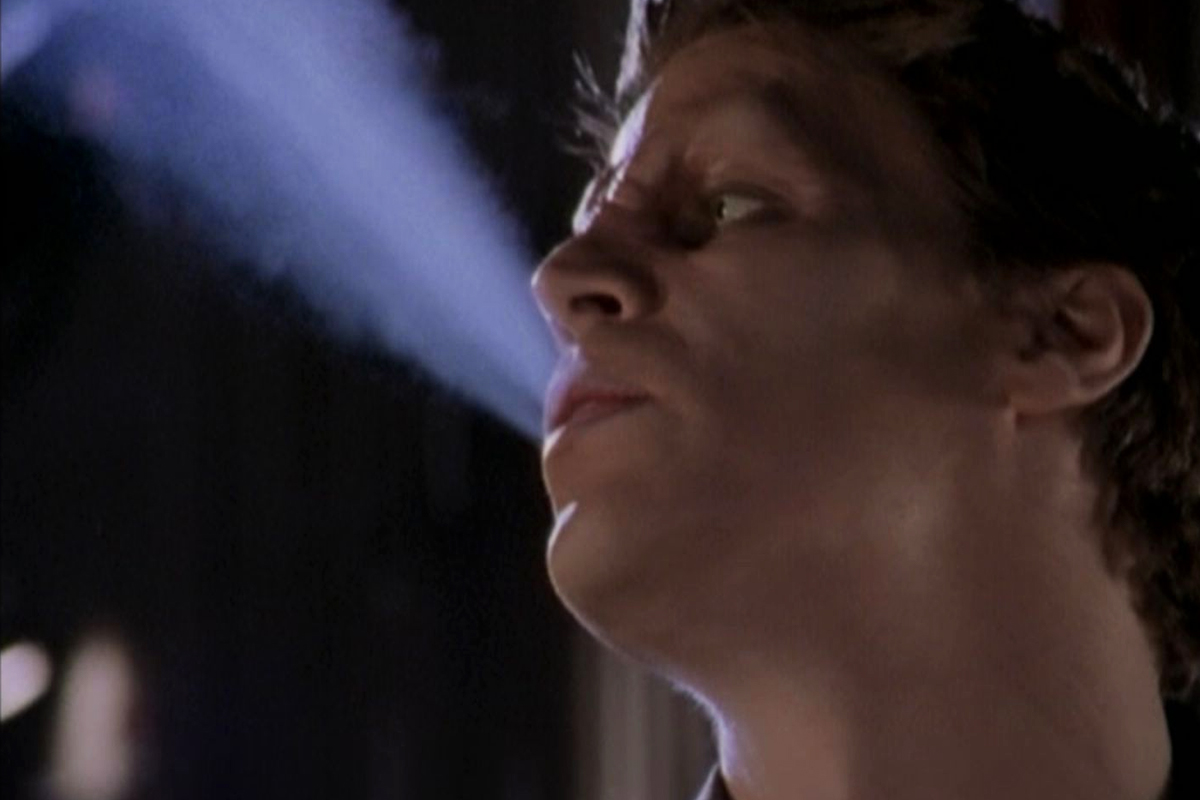 Angelus blows out smoke in the night air.