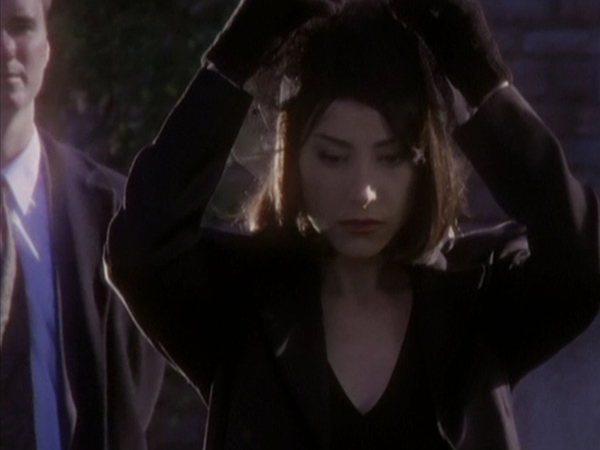 Jenny in mourning clothes at a funeral.