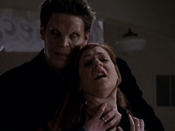 Angel holds Willow by the throat.