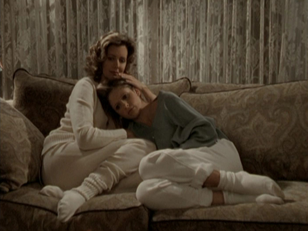 Joyce comforts Buffy on the sofa.