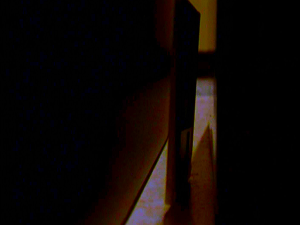 A floppy disk lies in the gap between desks.