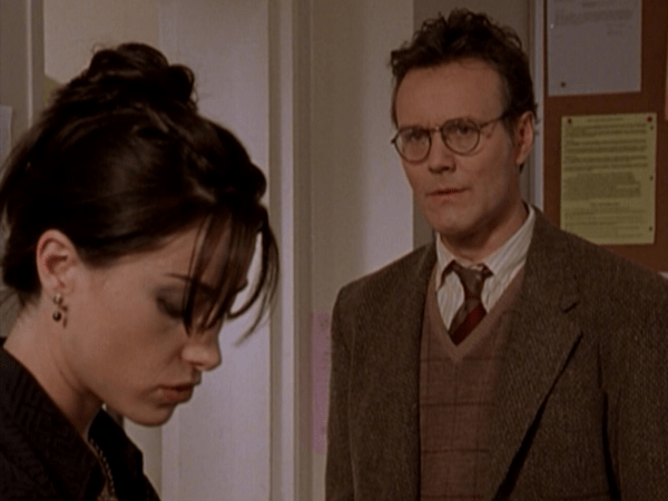 Jenny and Giles talk in Jenny's classroom.