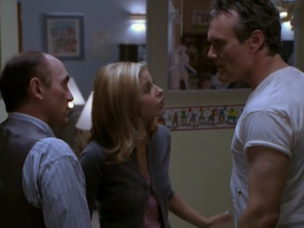 Buffy stands between Snyder and Giles, trying to encourage responsibility in both of them.