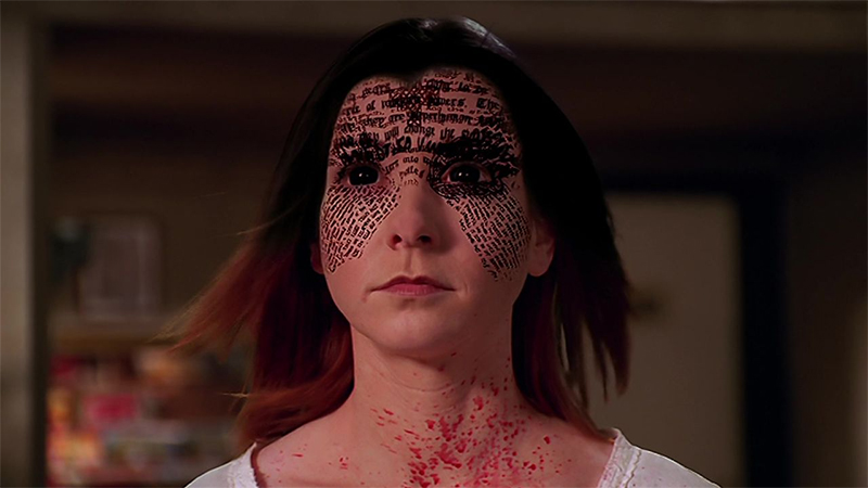 A shot from 'Villains' showing Willow absorving a book of dark magic and her eyes and hair turning black.