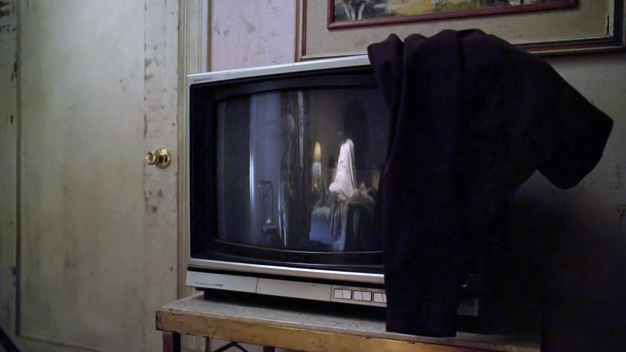 A shot of Faith and Xander reflected in a television screen.