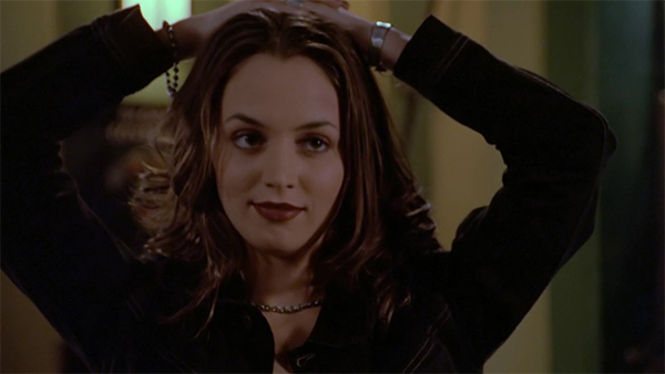 Faith standing with her hands on her head after being arrested.